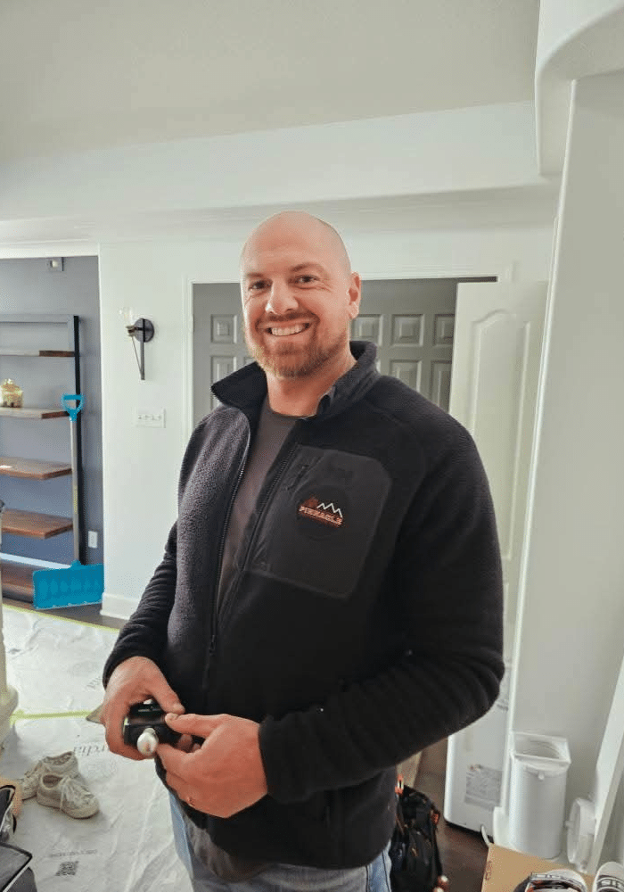Smiling man in a cozy room.