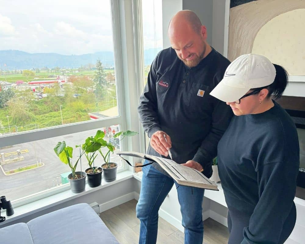 Two people discussing inspection details indoors.